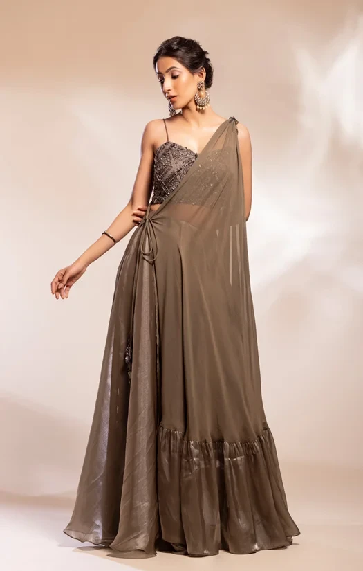 Grey Drape cape worn over bustier blouse and a full skirt